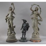 Two tall spelter figures, bot of women in classical poses, on circular wooden bases, both approx.