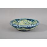 An early 20th century Moorcroft pottery bowl, blue and green glaze with floral decoration, scalloped