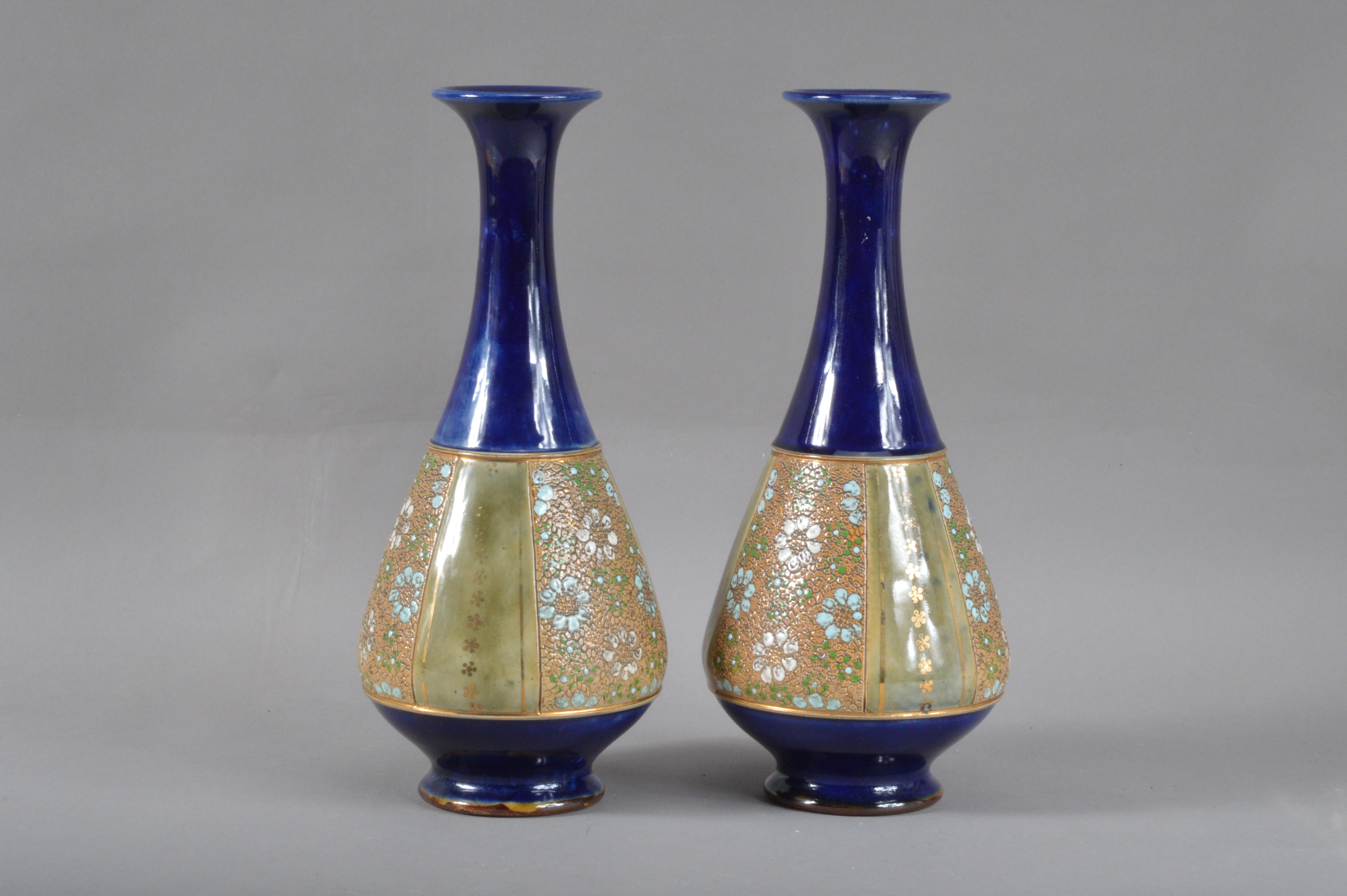 A pair of Royal Doulton stoneware vases, baluster form with long necks, with flared rims, blue