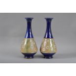 A pair of Royal Doulton stoneware vases, baluster form with long necks, with flared rims, blue