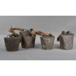 Four antique graduated sheep bells, two with primitive wooden straps, one with bone securing