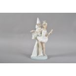 A Lladro porcelain figural group, titled Carnival Couple, a man and woman dancing, marked to the