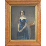 19th century School, a portrait of a lady in a blue dress, gouache, unsigned in a maple frame and