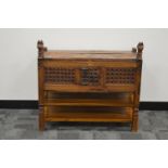 A 20th century hardwood Indian cabinet, carved horse finials on the front supports, a small