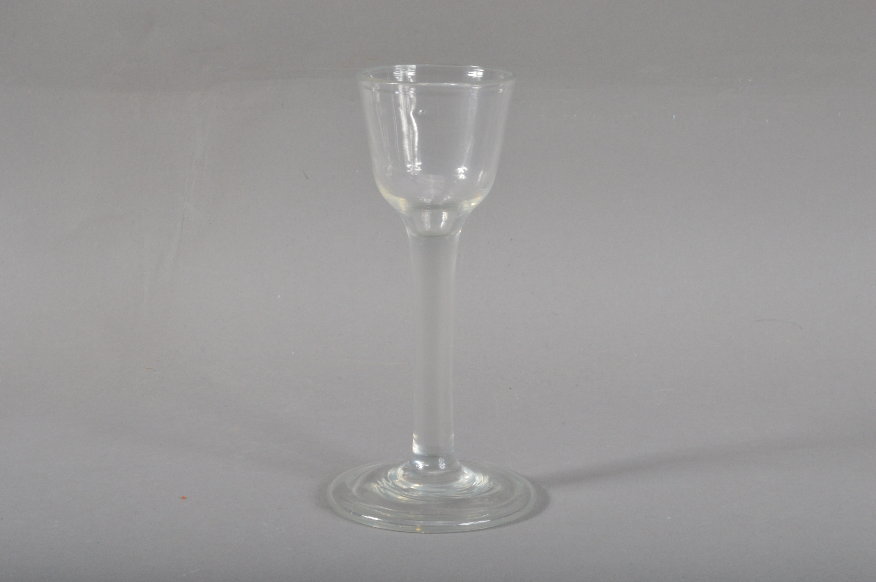 A George III lead wine or cordial drinking glass, with a folded base, 15cm high