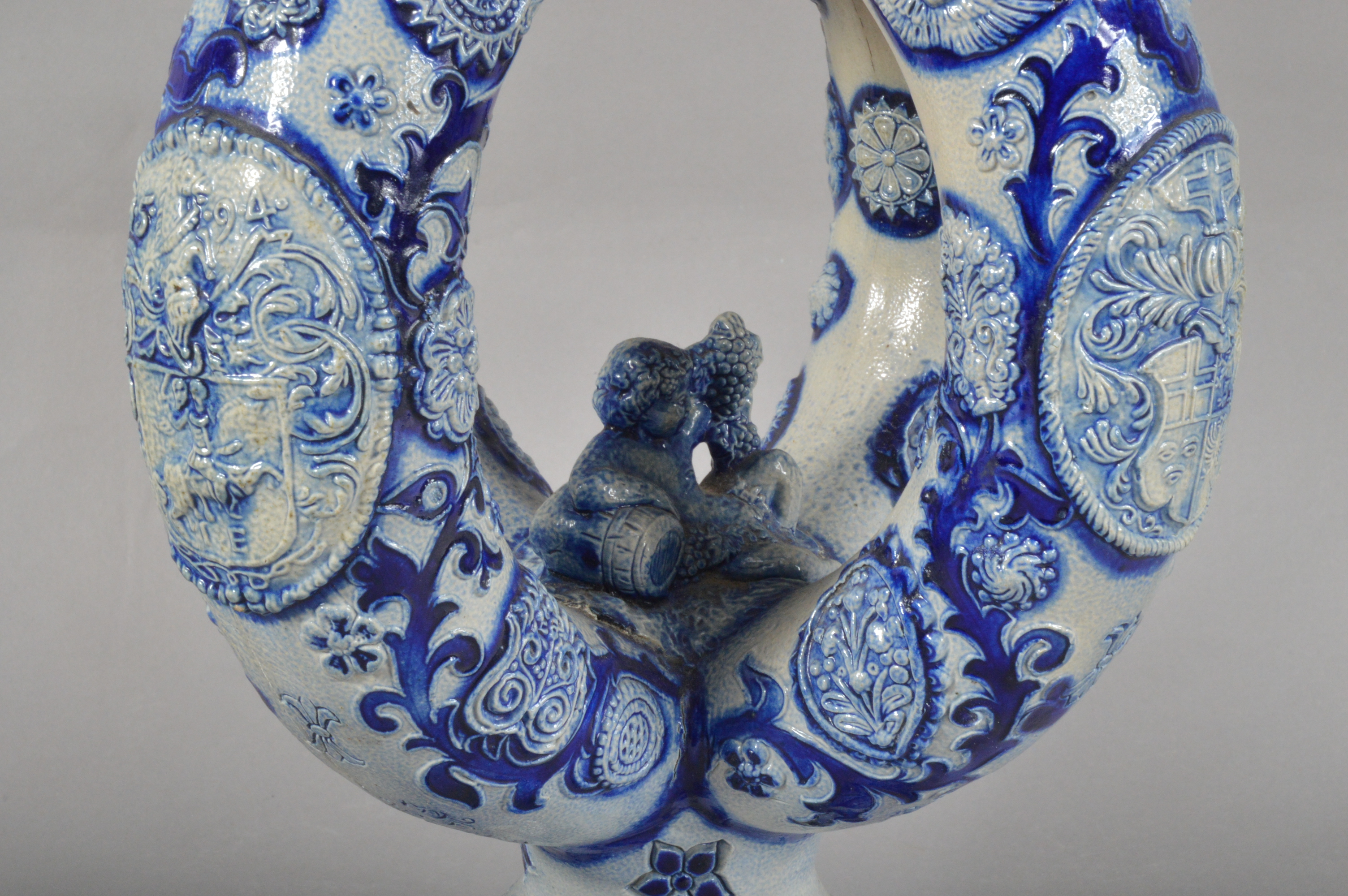 A German Westerwald salt-glazed stoneware ewer, blue and white raised decoration, a face below the - Image 2 of 5
