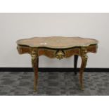 An early 20th century French faux tortoise shell and brass Boulle table, ebonised frame shaped top