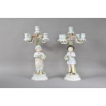 A pair of 20th century continental porcelain four branch candelabra's, the branches with floral
