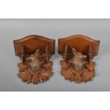 A pair of 20th century black forest carved wall brackets, carved leaves and busts of deer heads, the