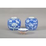 A pair of Chinese ginger jars, prunus blue and white decoration, both lids missing, both approx.