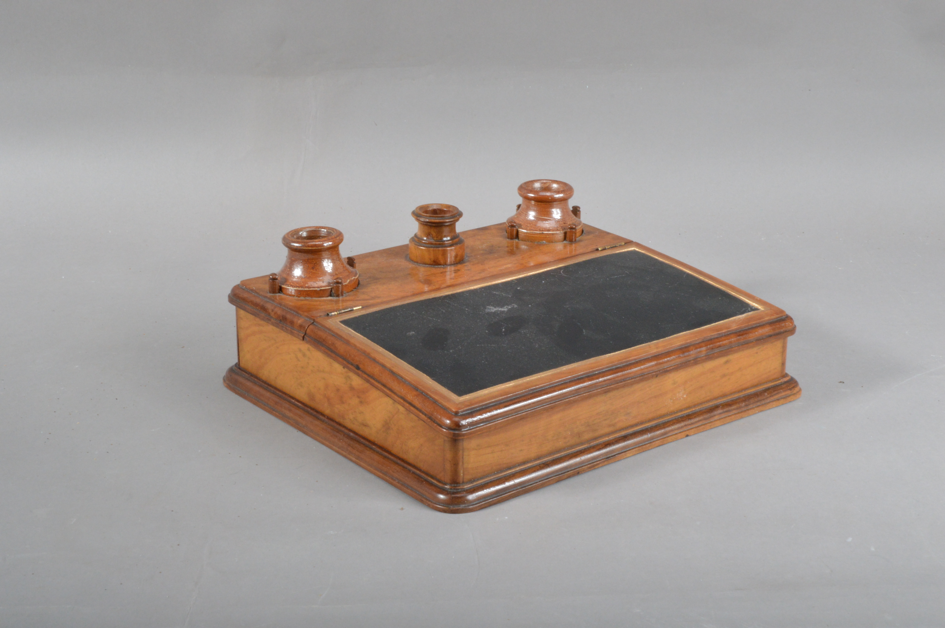 A 19th century olivewood and stoneware inkwell, two removable stoneware inkwells with a central