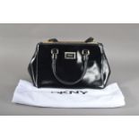A good condition black DKNY ladies handbag, with a DKNY branded cloth retail bag, 21cm x 29cm,