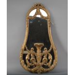 A modern gilt mirror, rococo foliate scroll design, with a central stand, 76cm high