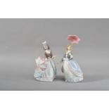 Two Lladro porcelain figurines, both ladies in 19th century outfits with parasols, both marked to