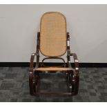 A late 20th century bent wood rocking chair, caned back and seat, appears in good condition, 97cm