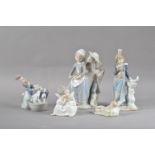 Five Lladro porcelain figurines, comprising a figural group of a boy and girl 22cm high, a '