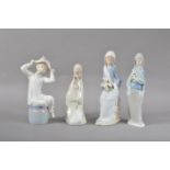 Four Lladro porcelain figurines, comprising a seated boy, 22cm high, two women with flowers,