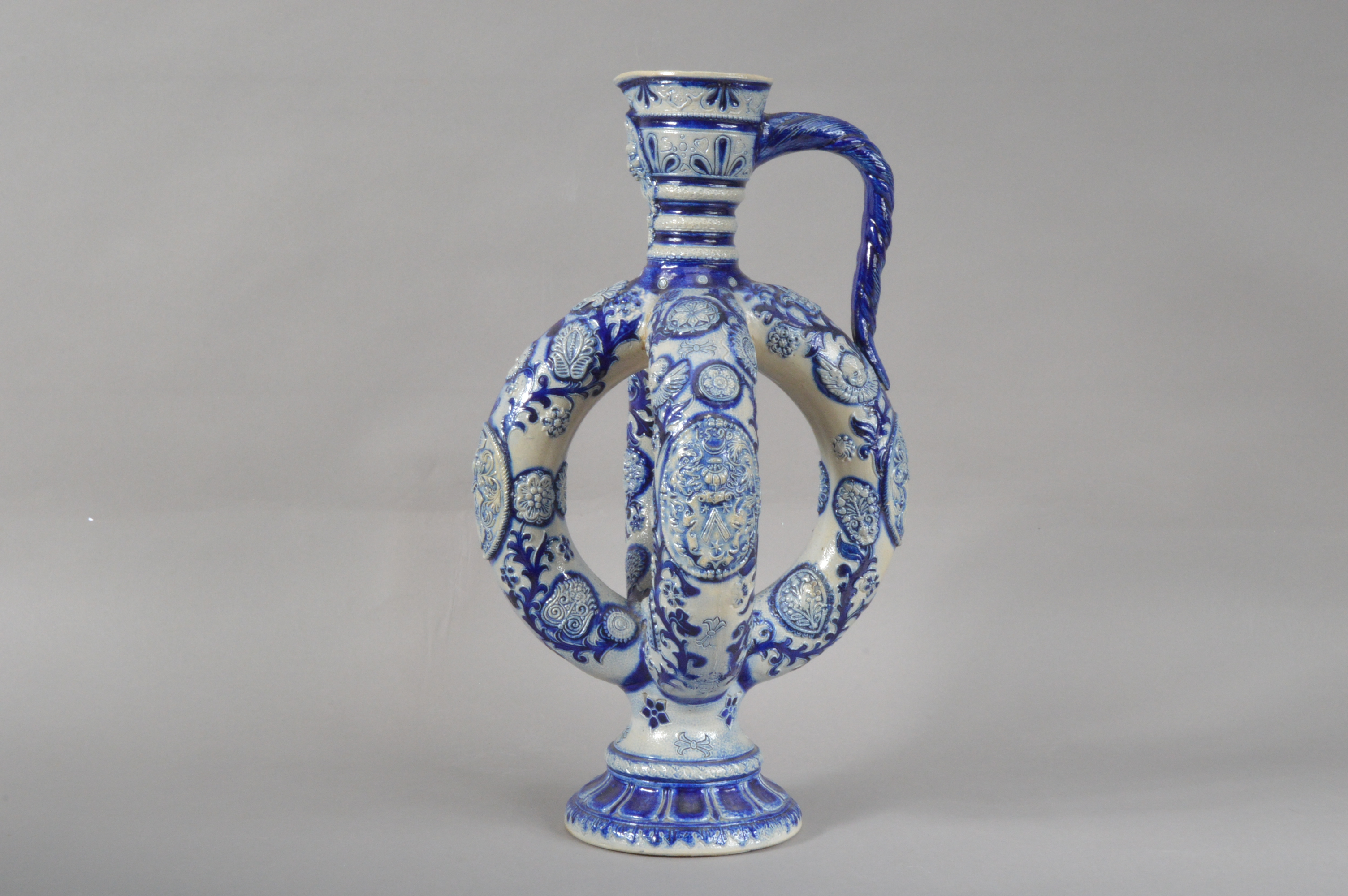 A German Westerwald salt-glazed stoneware ewer, blue and white raised decoration, a face below the - Image 4 of 5