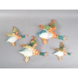 Four Beswick graduated flying duck wall hangings, all with impressed marks to the undersides, the