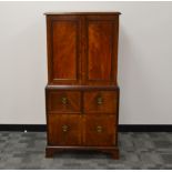 A small Edwardian mahogany and string inlaid cabinet, the top with two doors, enclosing two shelves,