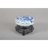 An early 20th century Chinese blue and white decorated porcelain ink pot and cover, the cover with a