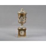 An impressive 19th century Elkington style silver plated urn and cover, the foliate scroll cover