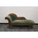 A Victorian walnut framed Chaise lounge, green worn velvet upholstery, button back, carved frame,