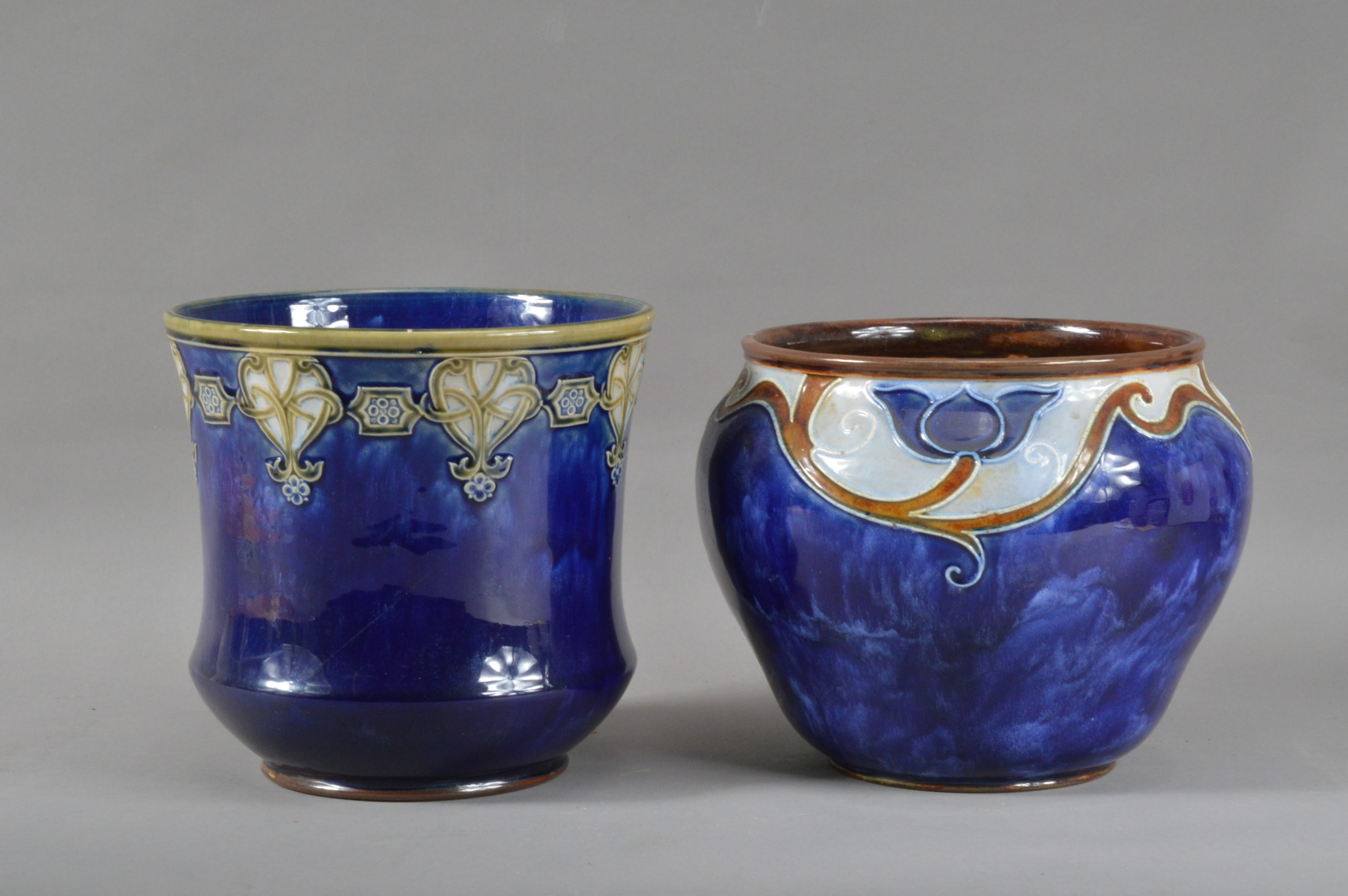 Two early 20th century Royal Doulton stoneware planters, one with a Celtic design, the other floral,