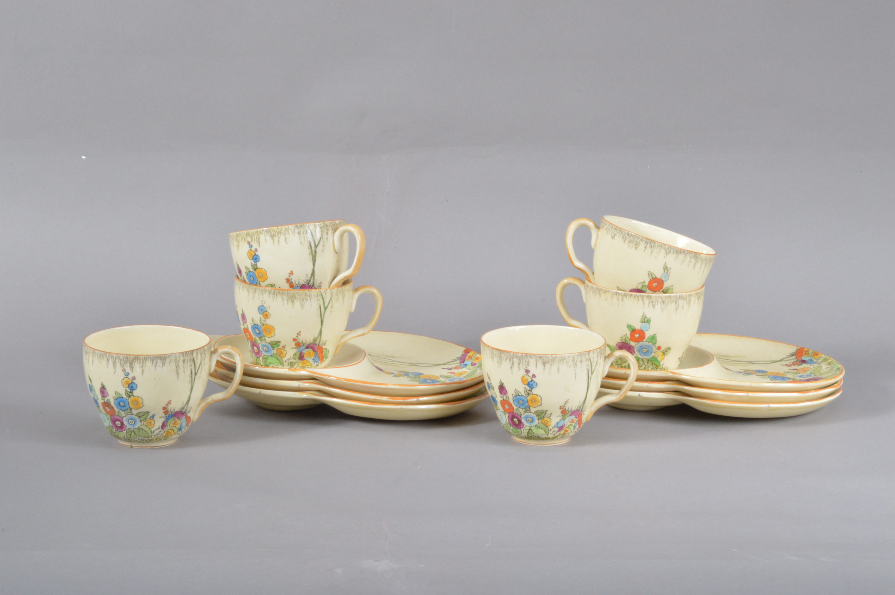 A set of six Crown Devon tea plates and cups, Summertime pattern, colourful decoration on a yellow/