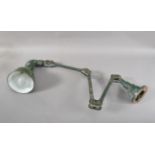 A 20th century Mek-Elek enamel and cast-iron instrumental lamp, green painted, marked towards the