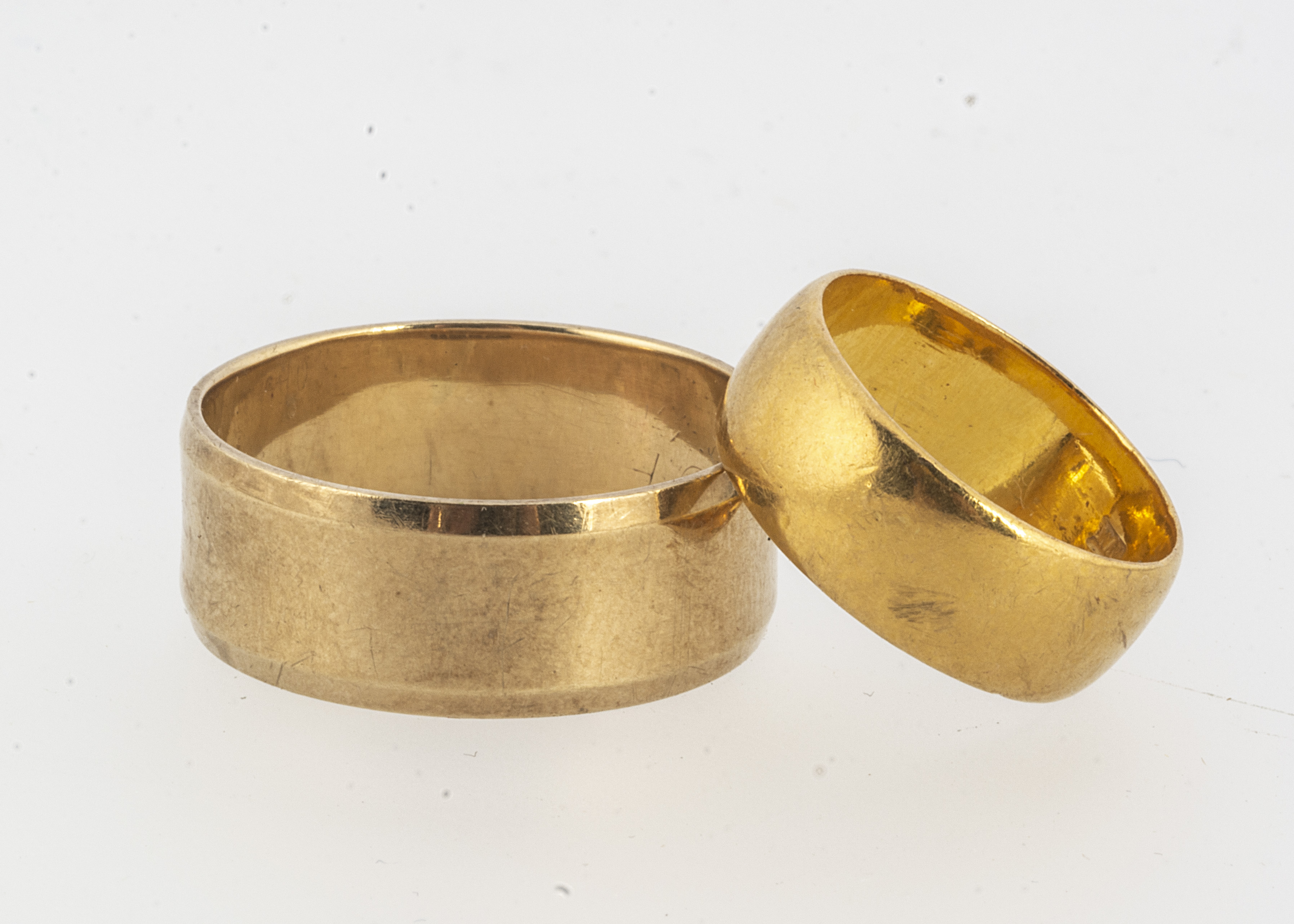 A George V 22ct gold flattened wedding band, the slightly domed band, 6.6 mm wide ring size I,