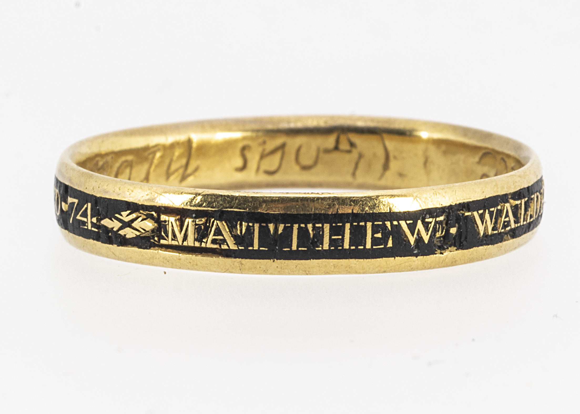 A mid 18th century Georgian mourning gold and enamel ring, ov plain band shape, the outer shank with