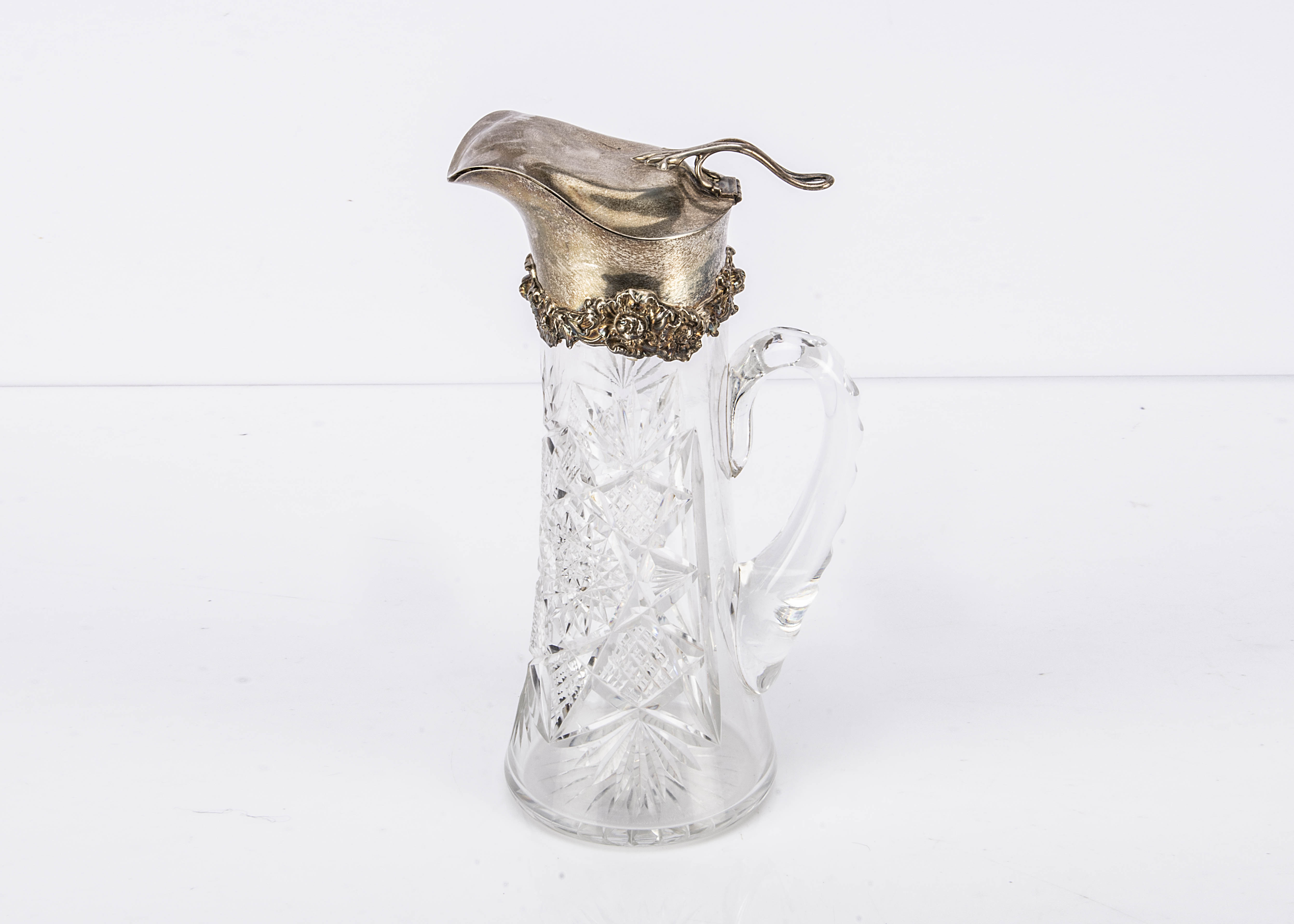 An early George V cut glass and silver mounted claret jug from G M Co, 29cm, the hinged cap and a