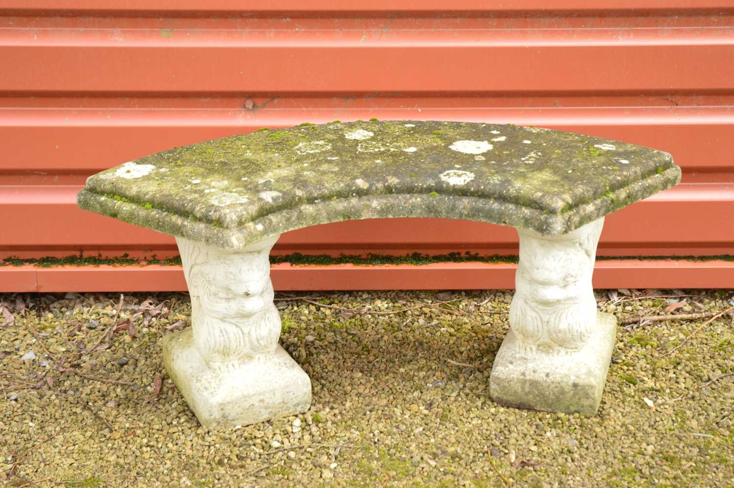 A carved stone and concrete bench,