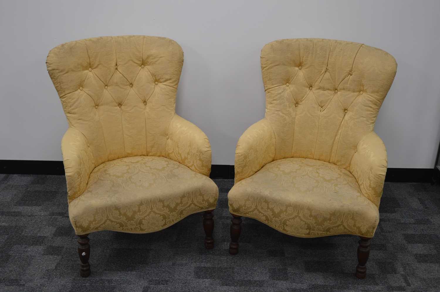 A pair of 20th century button back lounge armchairs,