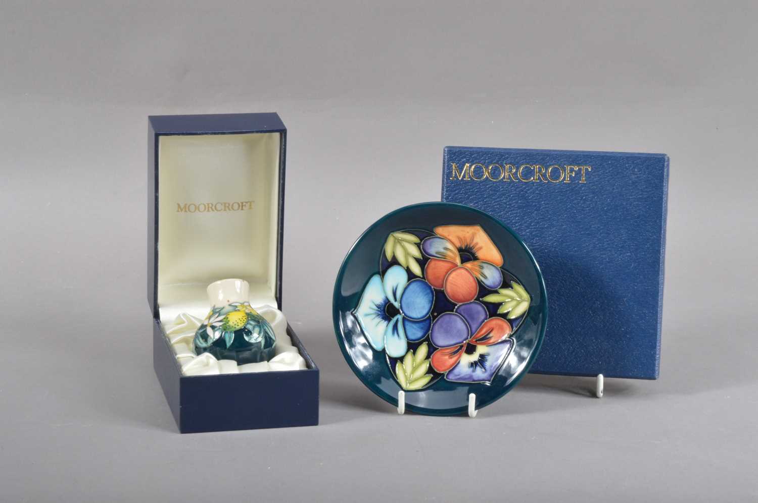 Two boxed modern items of Moorcroft Pottery,