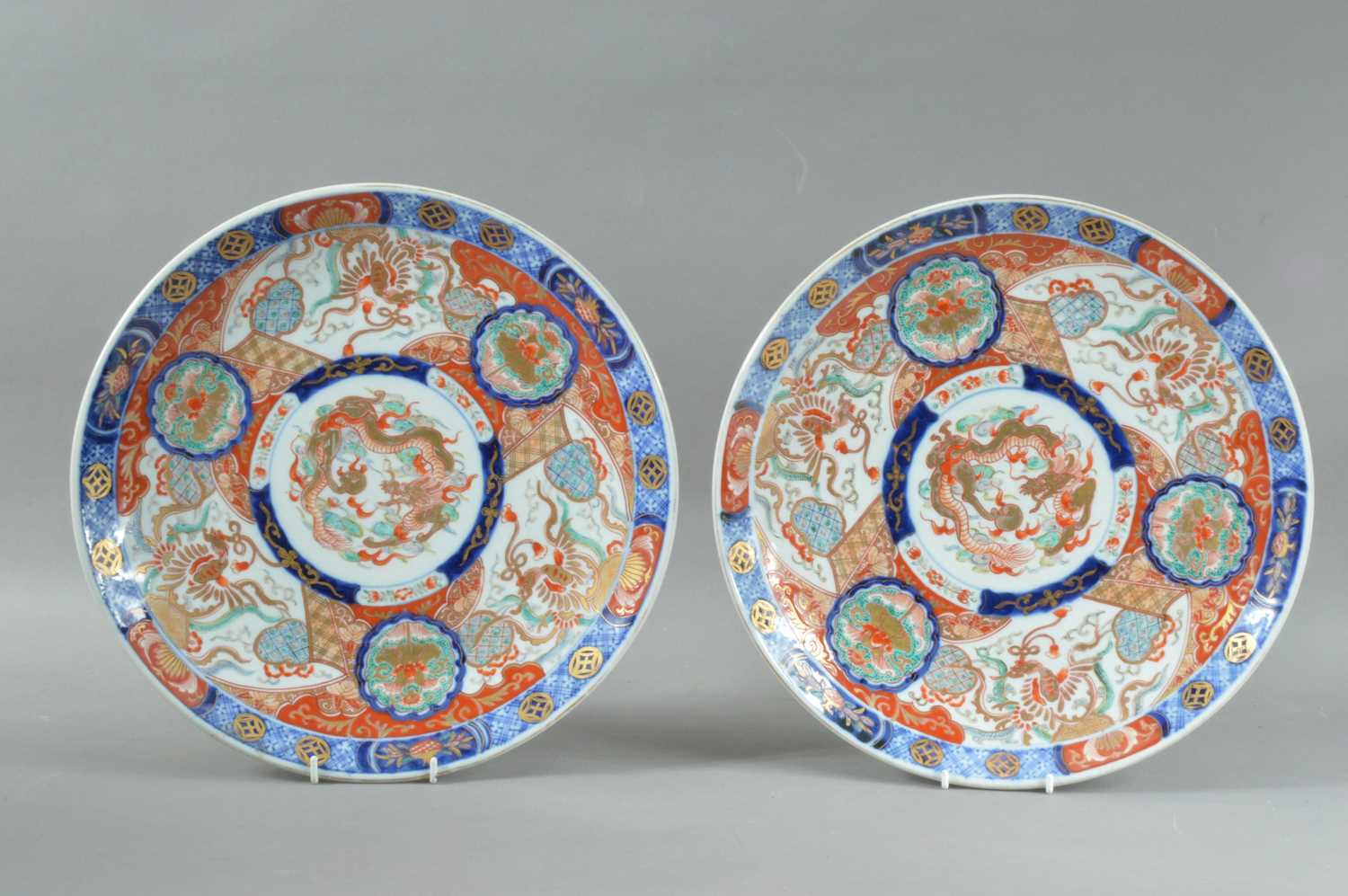 A pair of late Meiji period Japanese porcelain Imari large dishes,