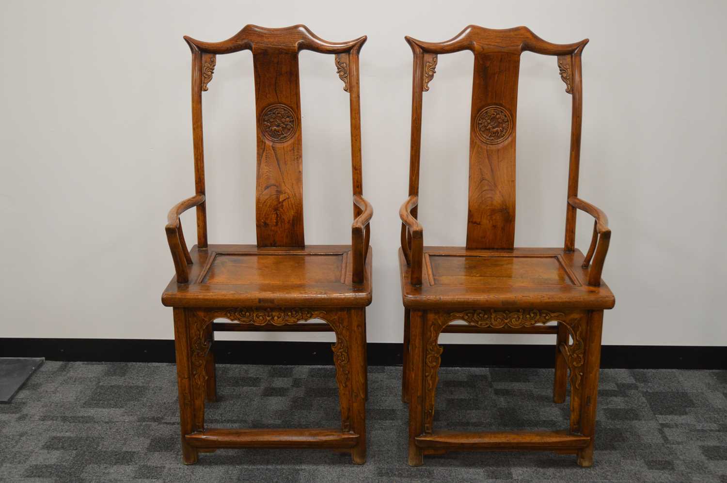 A pair of impressive Chinese hardwood marriage armchairs,