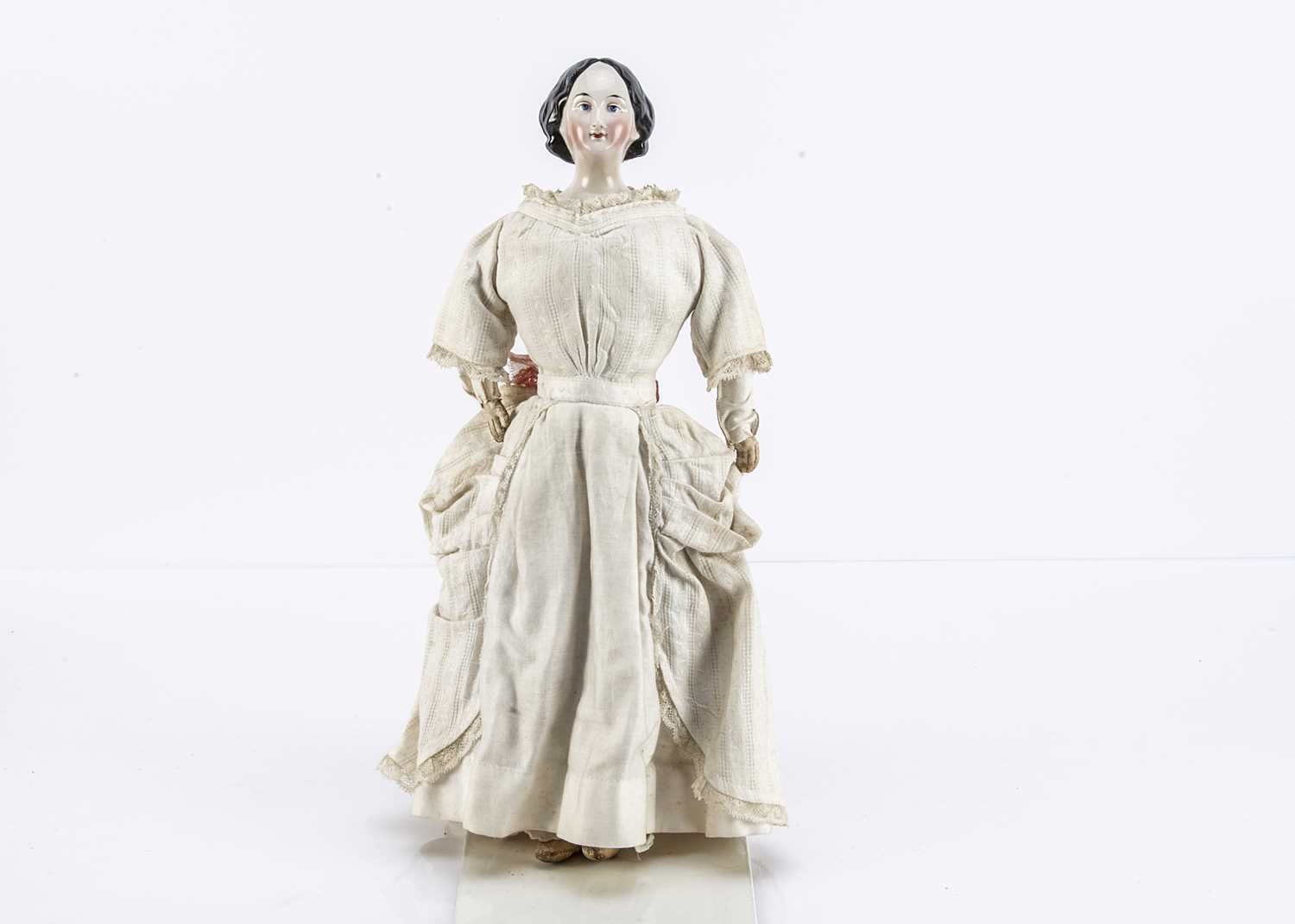 A fine German mid 19th century china shoulder-head doll with elaborate hair,