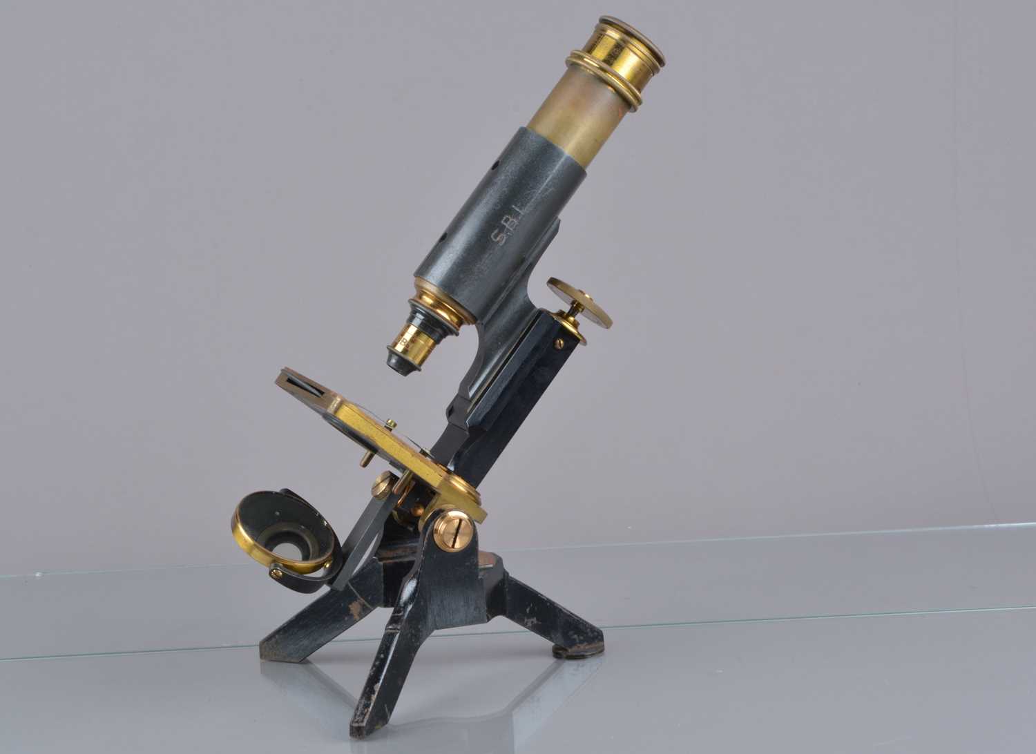 A late-19th Century lacquered and black-enamelled brass Compound Monocular Microscope engraved Jas P