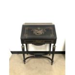 An early 20th century French ebonised and brass inlaid writing table,