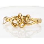 An early 20th Century yellow metal knot bangle,