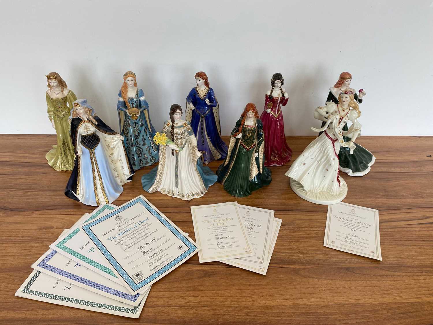 A set of nine modern Royal Worcester Celtic Maiden porcelain figures,