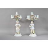 A pair of 20th century continental porcelain four branch candelabra's,