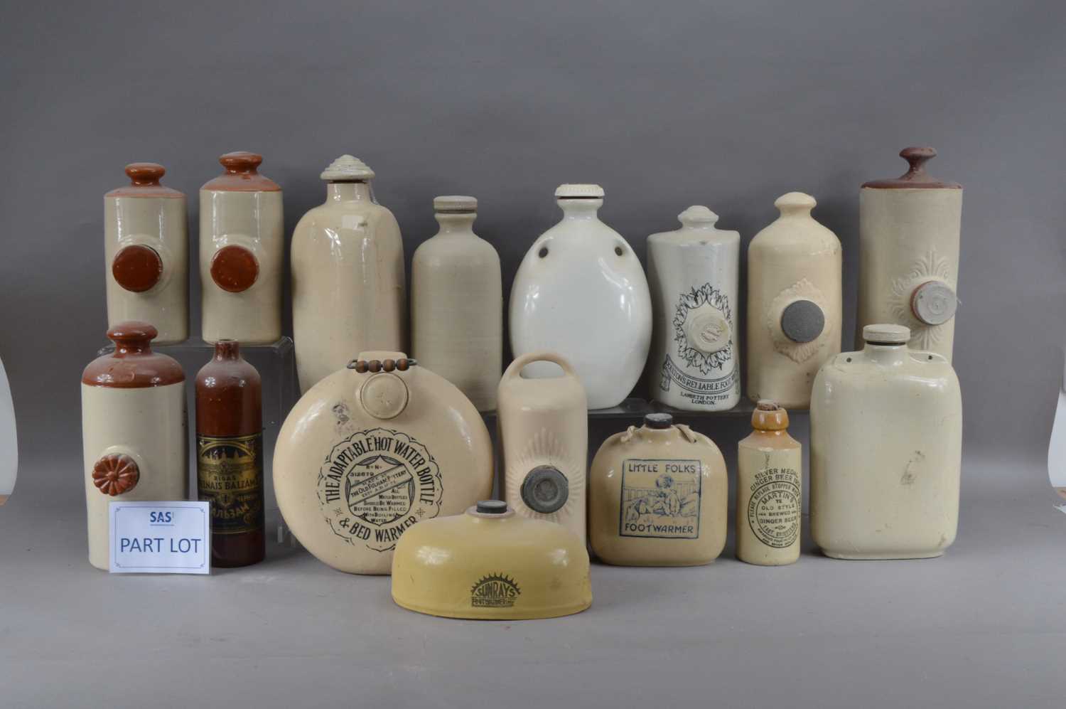 A large collection of 19th century and later stoneware hot water bottles,