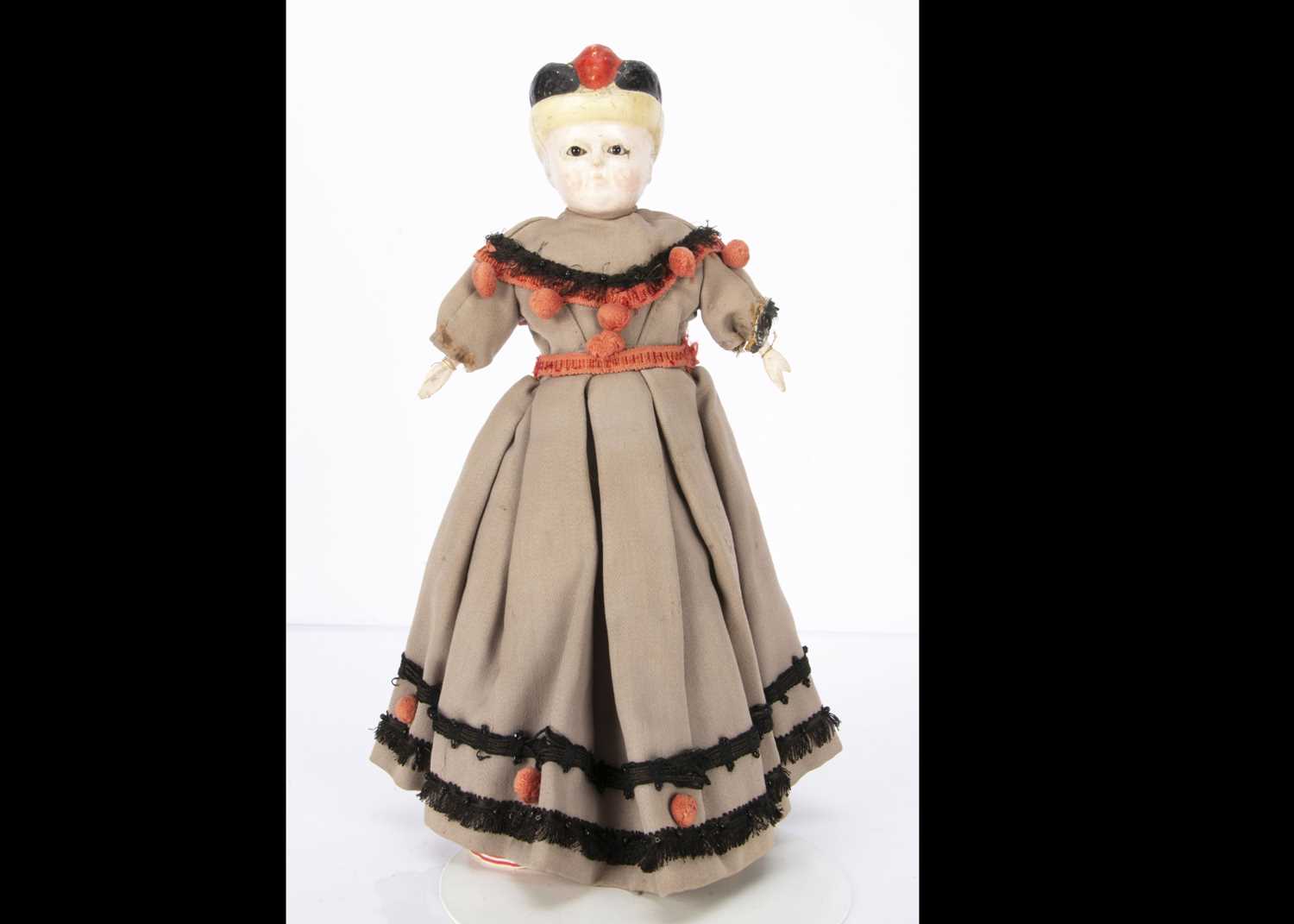 A mid 19th century German wax over composition Pumpkin head doll with moulded bonnet,