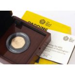 A Royal Mint 2018 Paddington At The Station gold proof 50 pence coin,