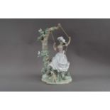 A large Lladro porcelain figurine of a lady on a swing,