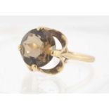 A yellow metal smoky quartz dress ring,