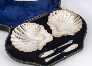 A cased pair of Edwardian silver butter dishes and knives,